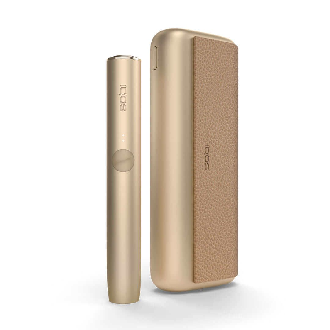  IQOS Iluma Prime UK. Showcasing the Gold colour variation of the IQOS Iluma Prime. IQOS Iluma Prime on white background with shadow included. All colours of the IQOS Iluma Prime at 888 Vapour available from £108.99 with 60 free terea sticks. 3 Packs of T