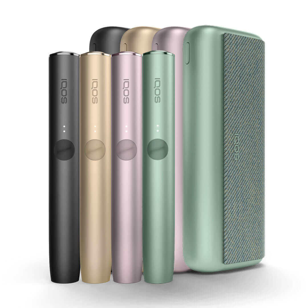 IQOS Iluma Prime UK. Showcasing the Black, Grey, Pink, Blue and Green colour variations of the IQOS Iluma Prime. IQOS Iluma Prime on white background with shadow included. All colours of the IQOS Iluma Prime at 888 Vapour available from £108.99 with 60 fr